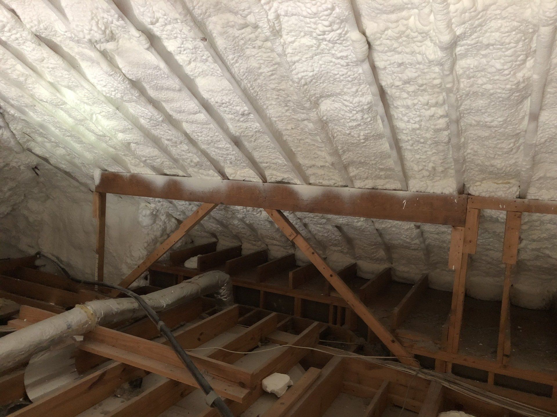 spray foam on the ceiling of the attic .