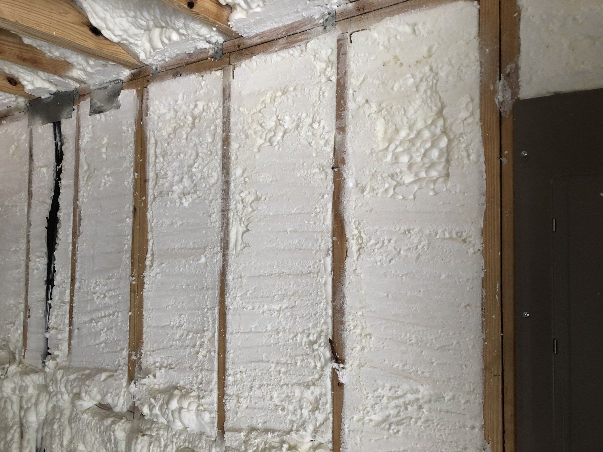 a wall with trimmed spray foam on it