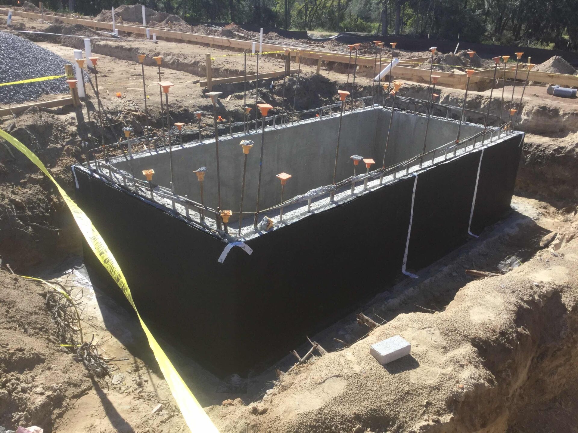 a large concrete structure is being built in the dirt