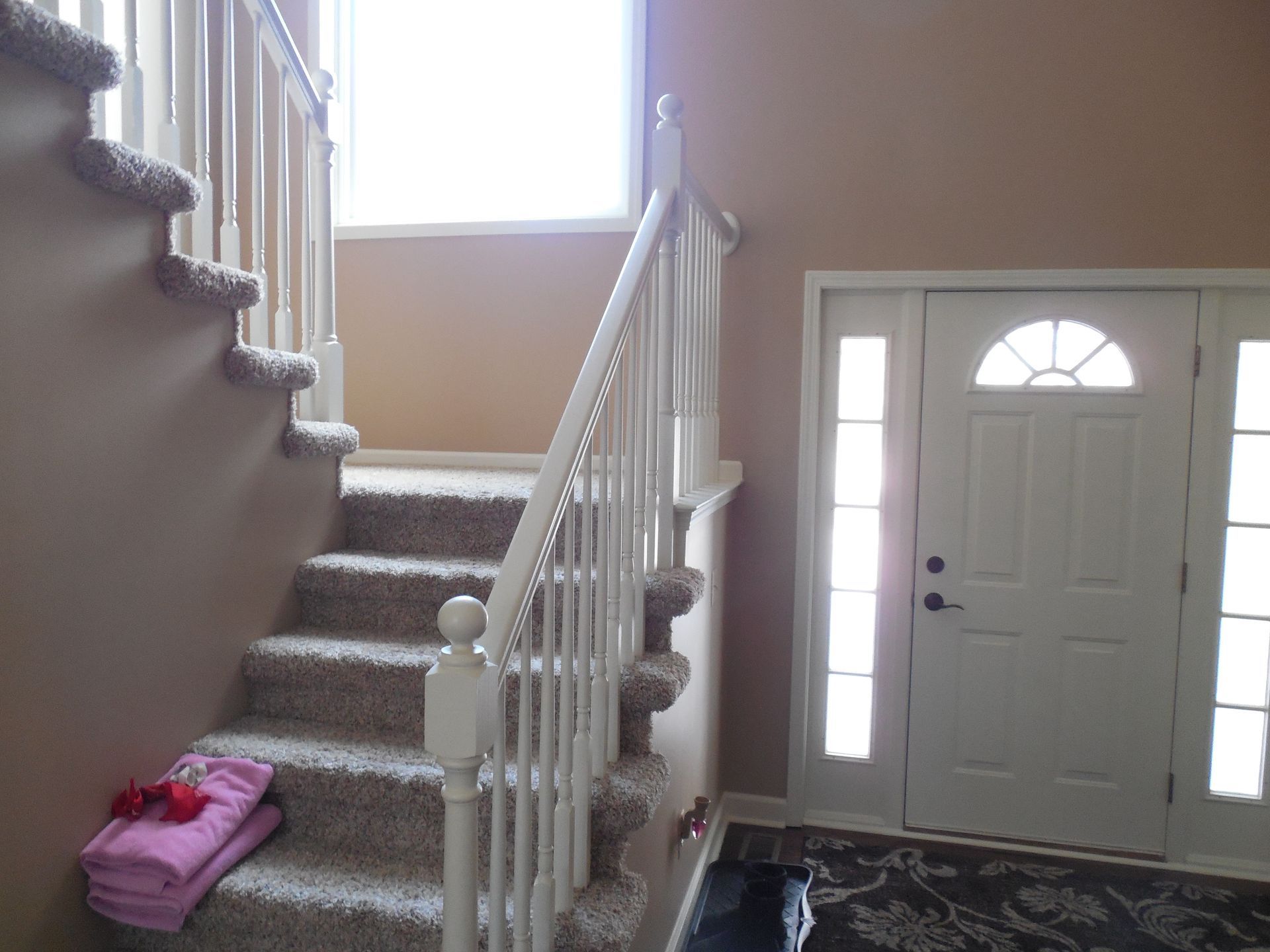 A staircase in a house with a white railing