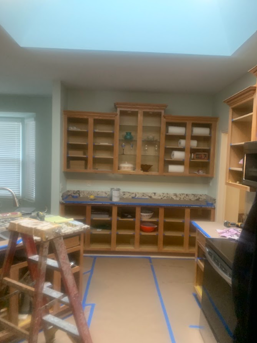 A kitchen under construction with a ladder in the middle