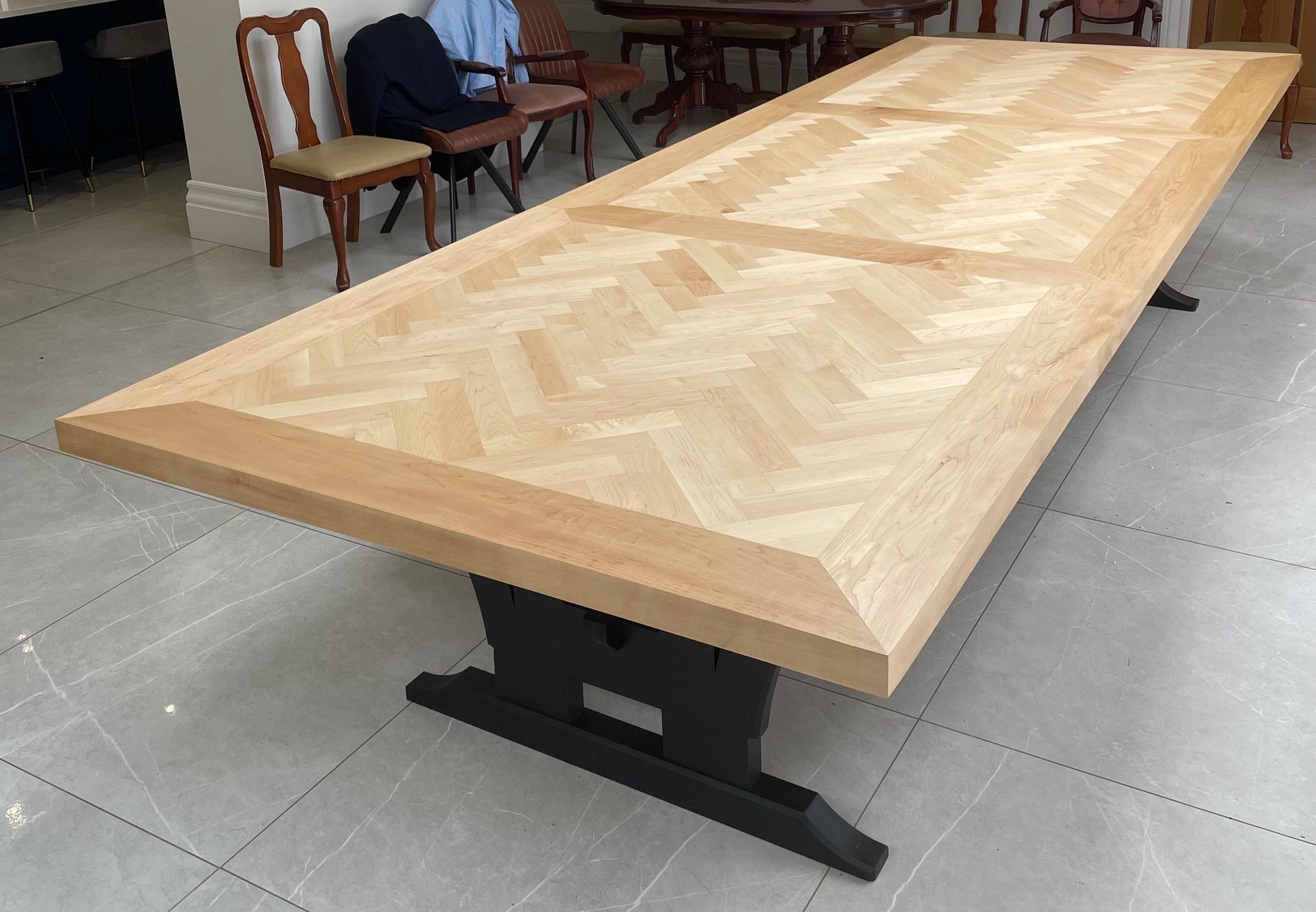 A long wooden table with a herringbone pattern