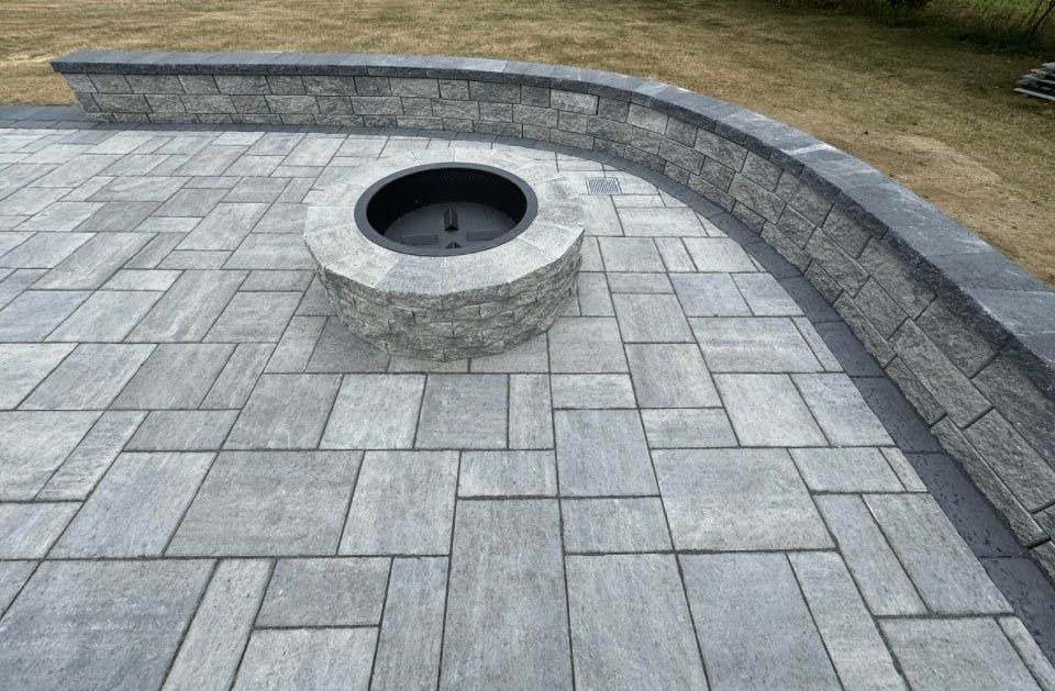 There is a fire pit in the middle of the patio.