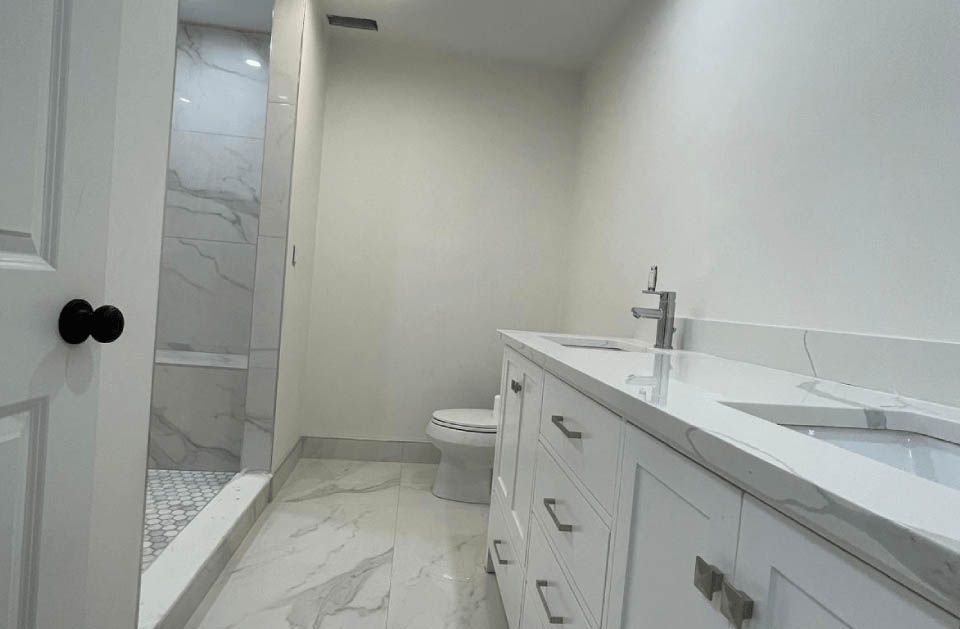 A bathroom with a toilet , sink , and shower.