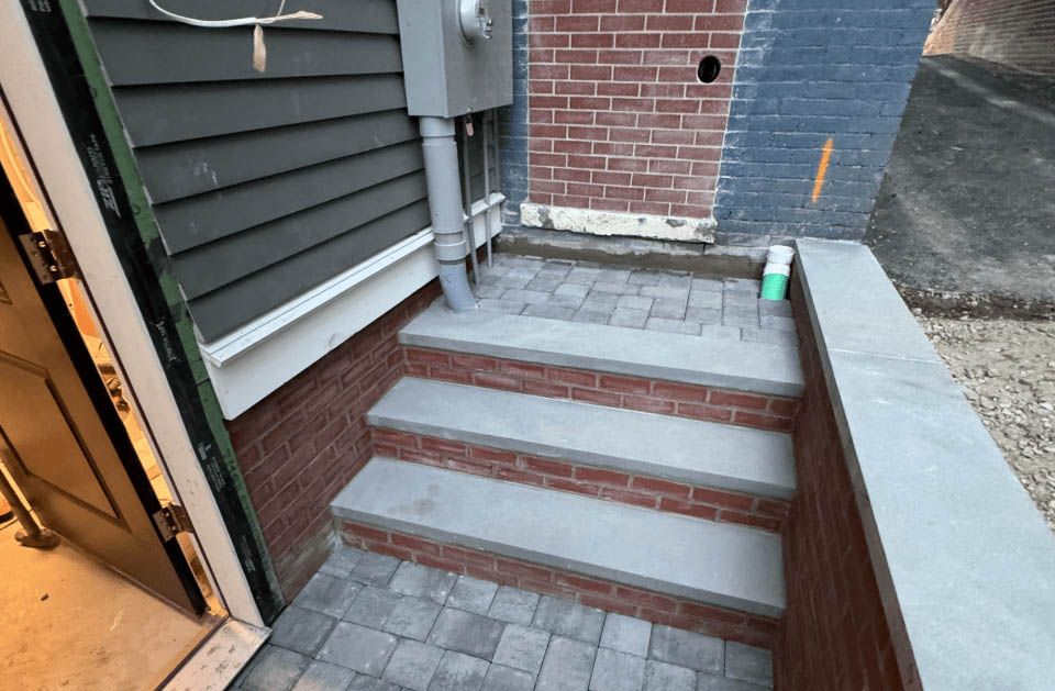 A set of stairs leading up to a brick building