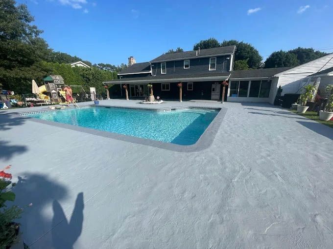 A large swimming pool in front of a house