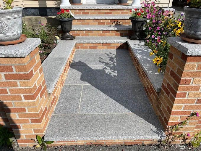 A brick walkway leading up to a set of stairs