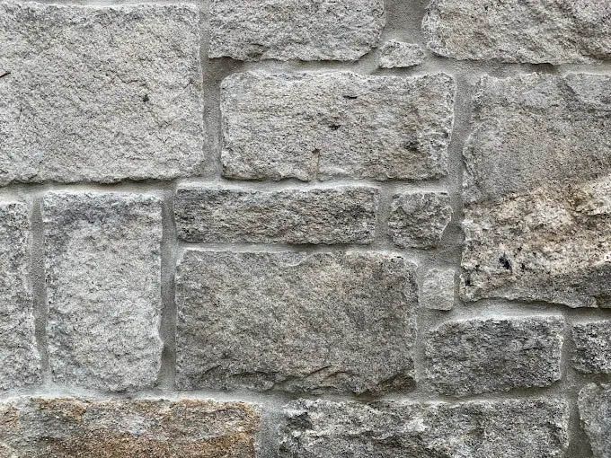 A close up of a stone wall with a lot of bricks