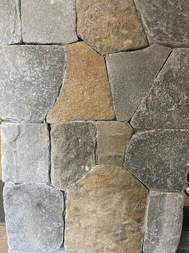 A close up of a stone wall with a geometric pattern.