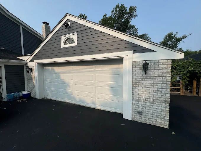 A garage with a white door and a brick wall