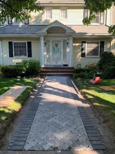 A walkway is being built in front of a house.