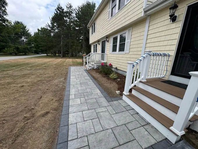 A house with a patio and stairs in front of it.