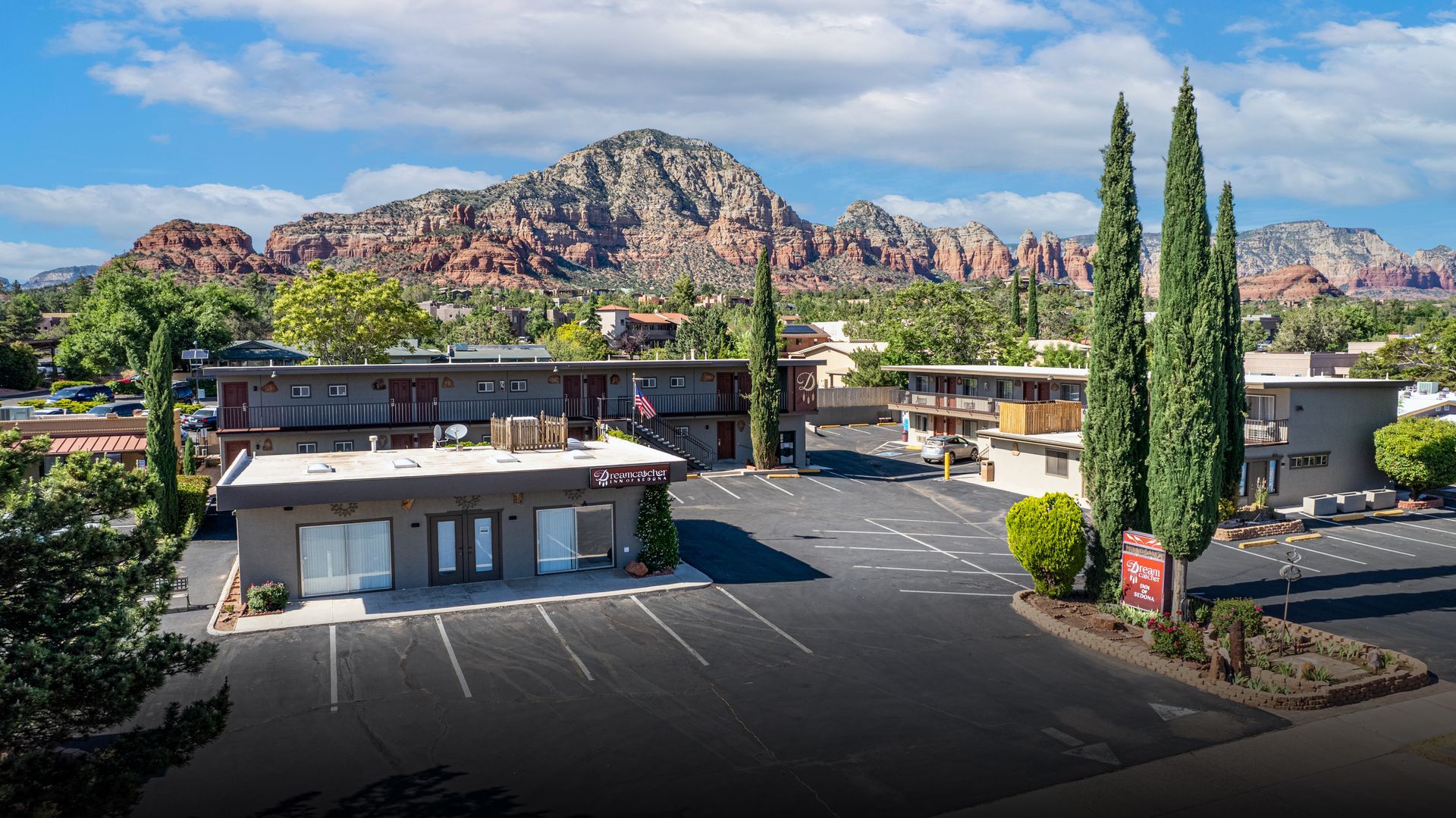 An aerial view of a hotel with a mountain in the background.