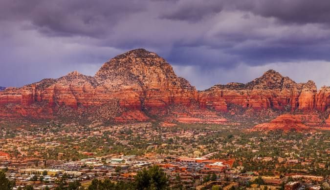 View of Airport Mesa mountain with trees and blue sky in Sedona near Dreamcatcher Inn