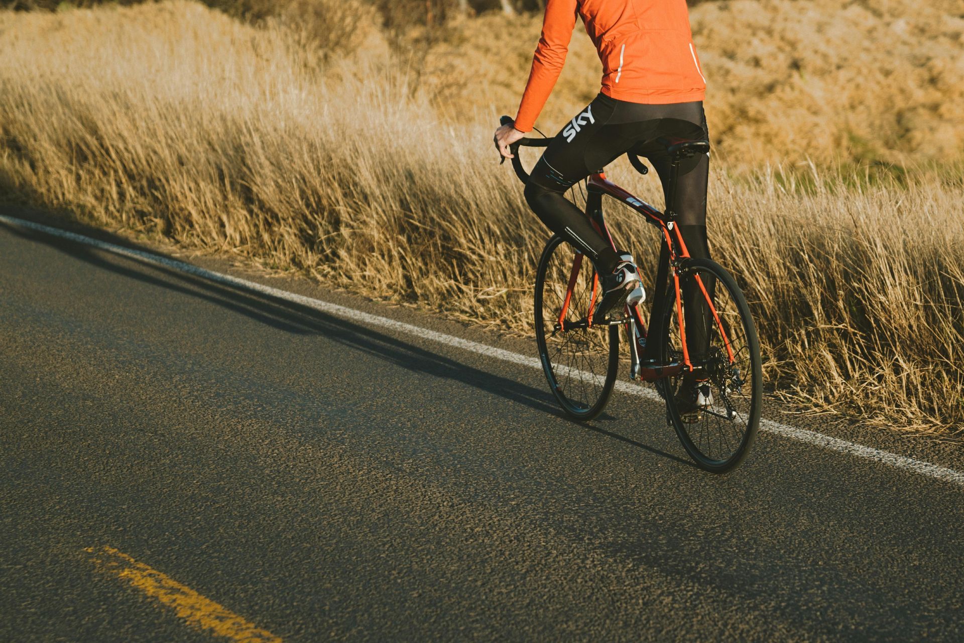 Person biking down scenic Sedona road near Dreamcatcher Inn
