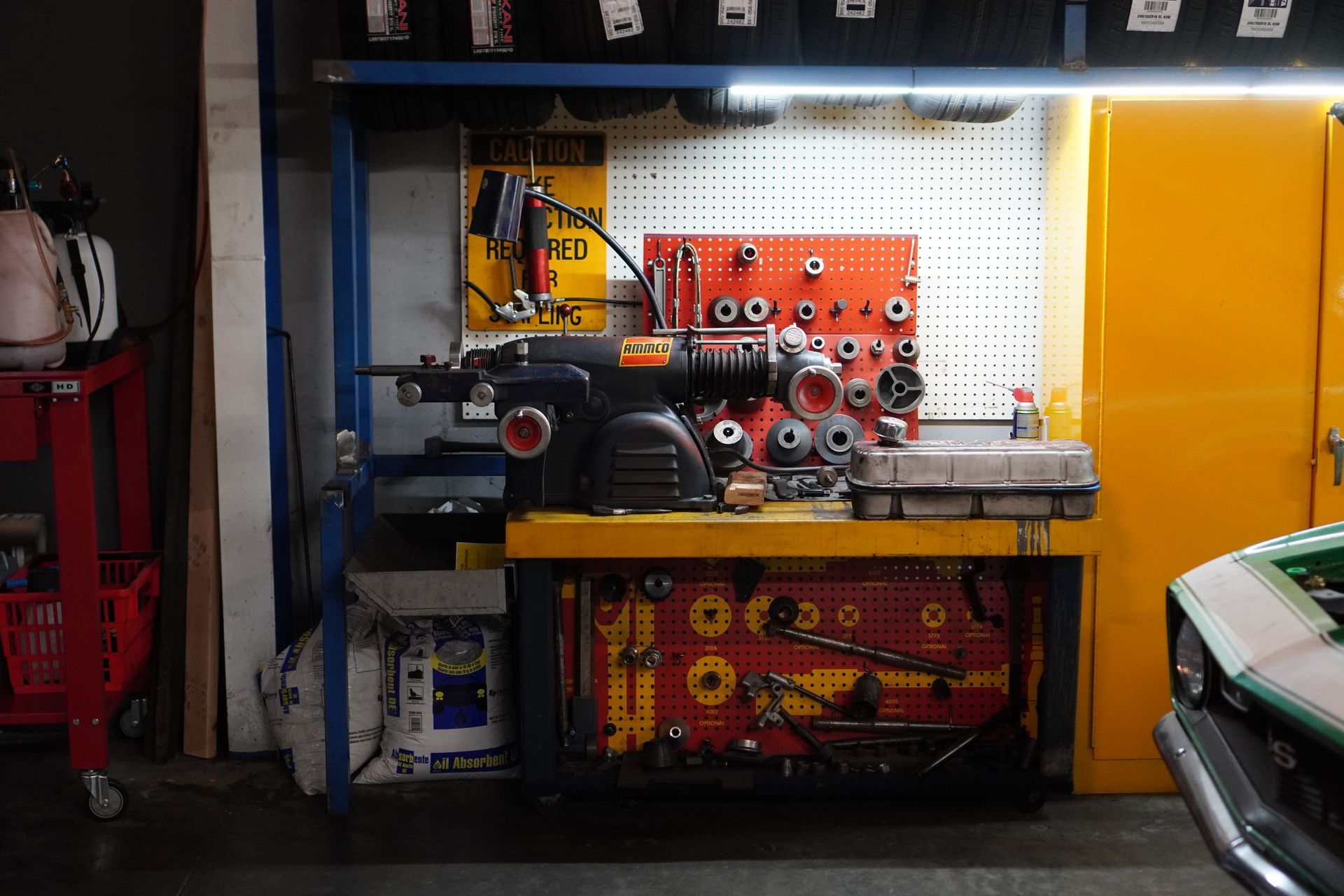 Mechanic's workspace with tools organized on a workbench; a car is partially visible. | Platinum Motors Martinez