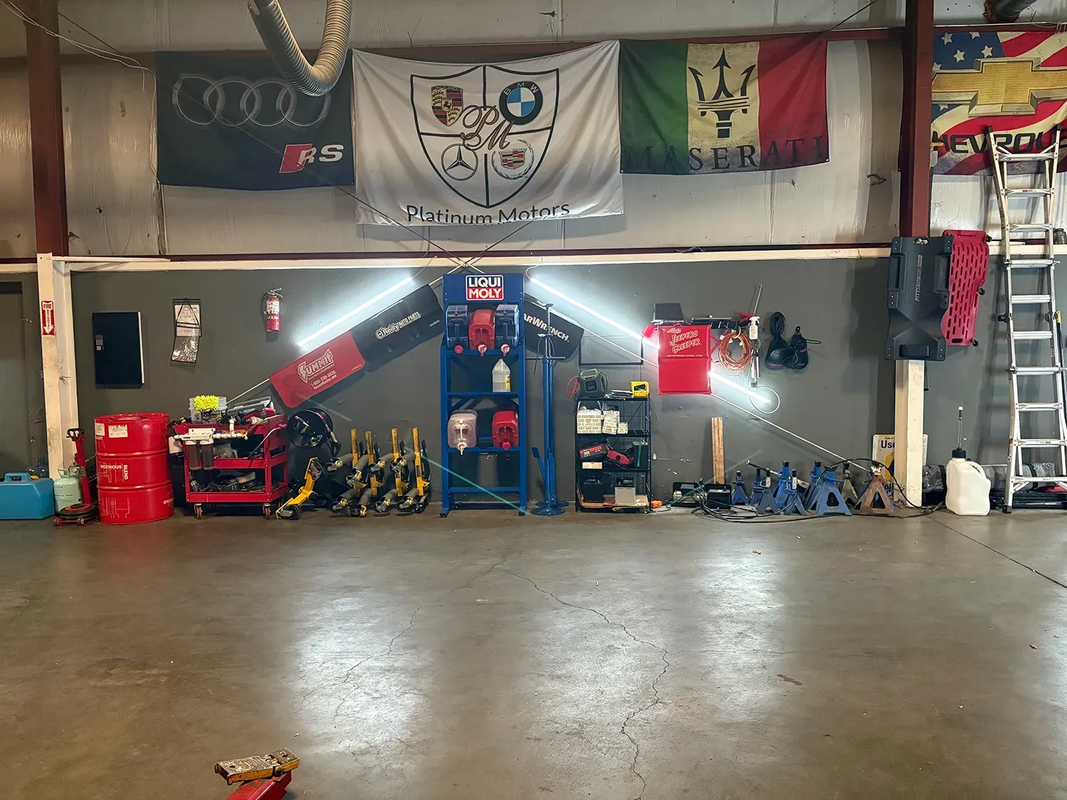 Flags hung up inside of our garage | Platinum Motors Martinez