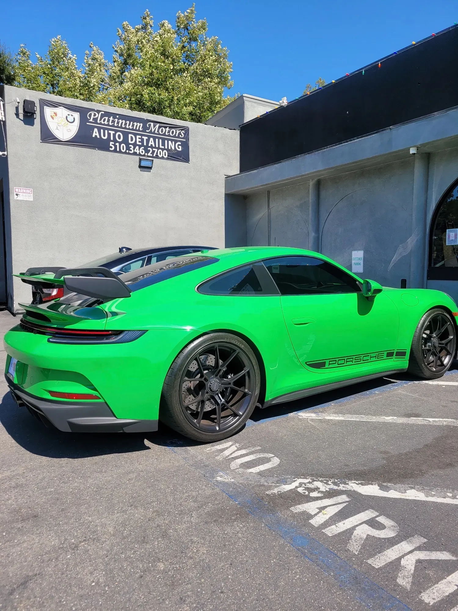 Green Porsche parked outside | Platinum Motors Martinez