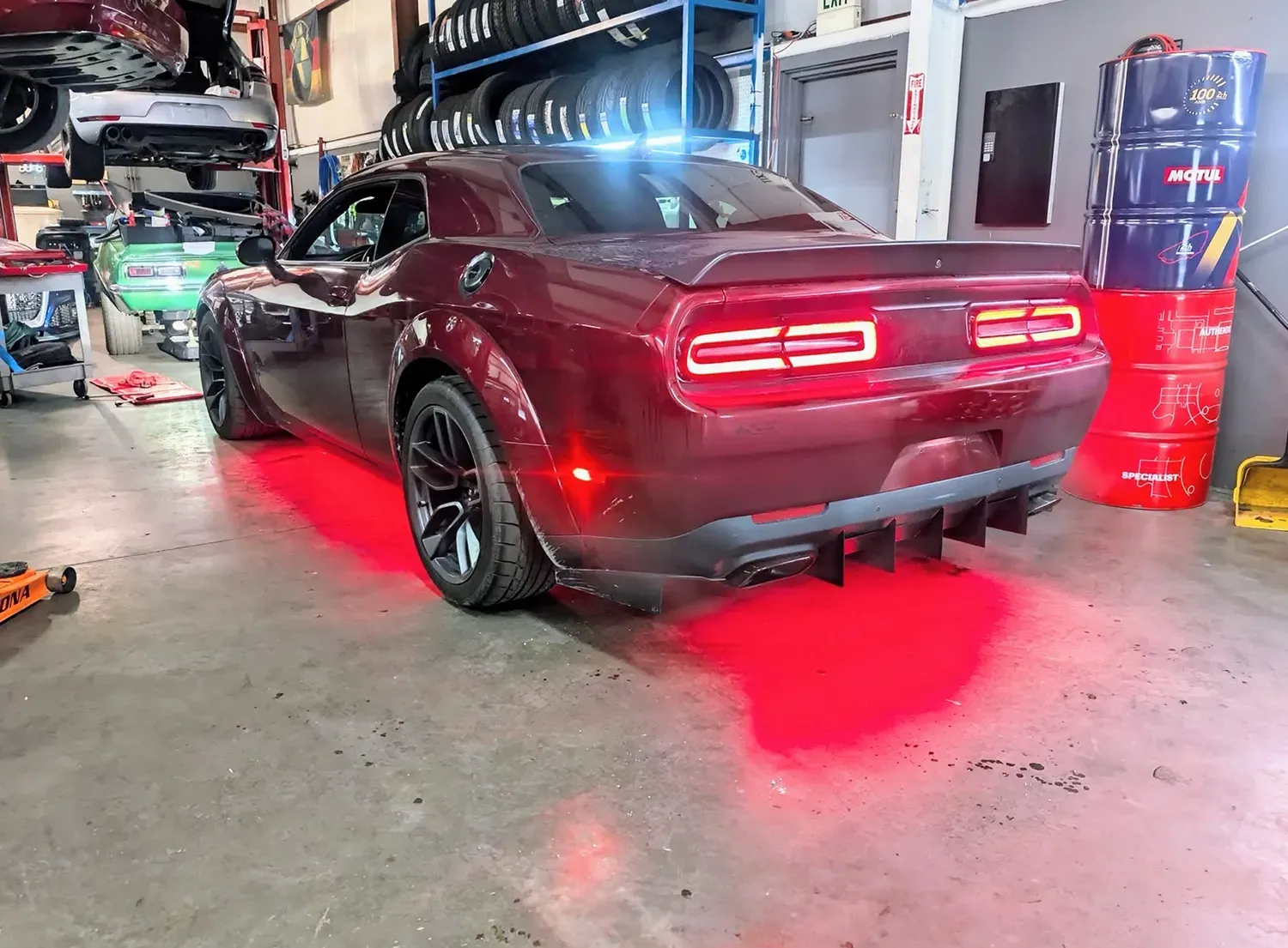 Red car with brake lights on in our garage | Platinum Motors Martinez
