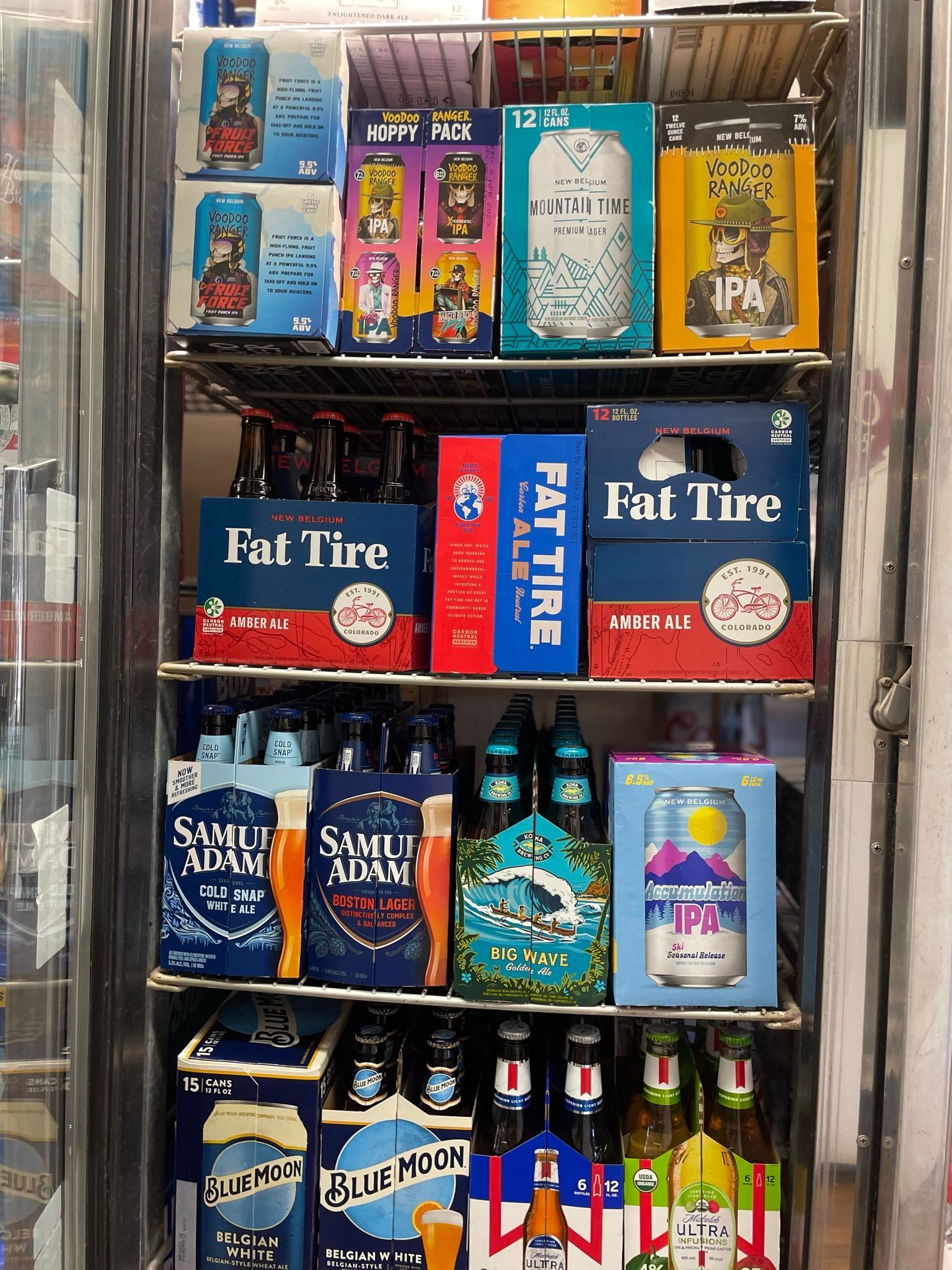 A refrigerator filled with bottles and boxes of beer.