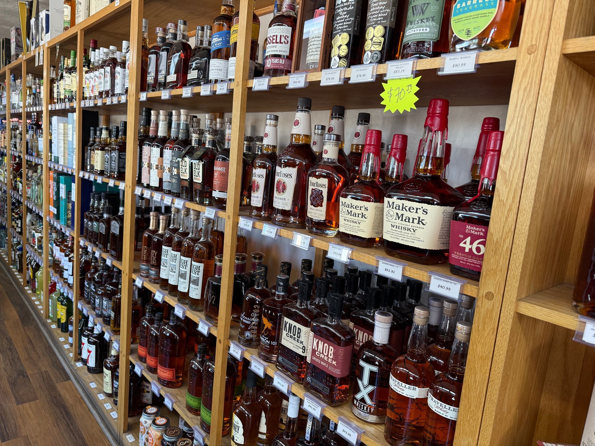 A man is talking to a woman in a liquor store.