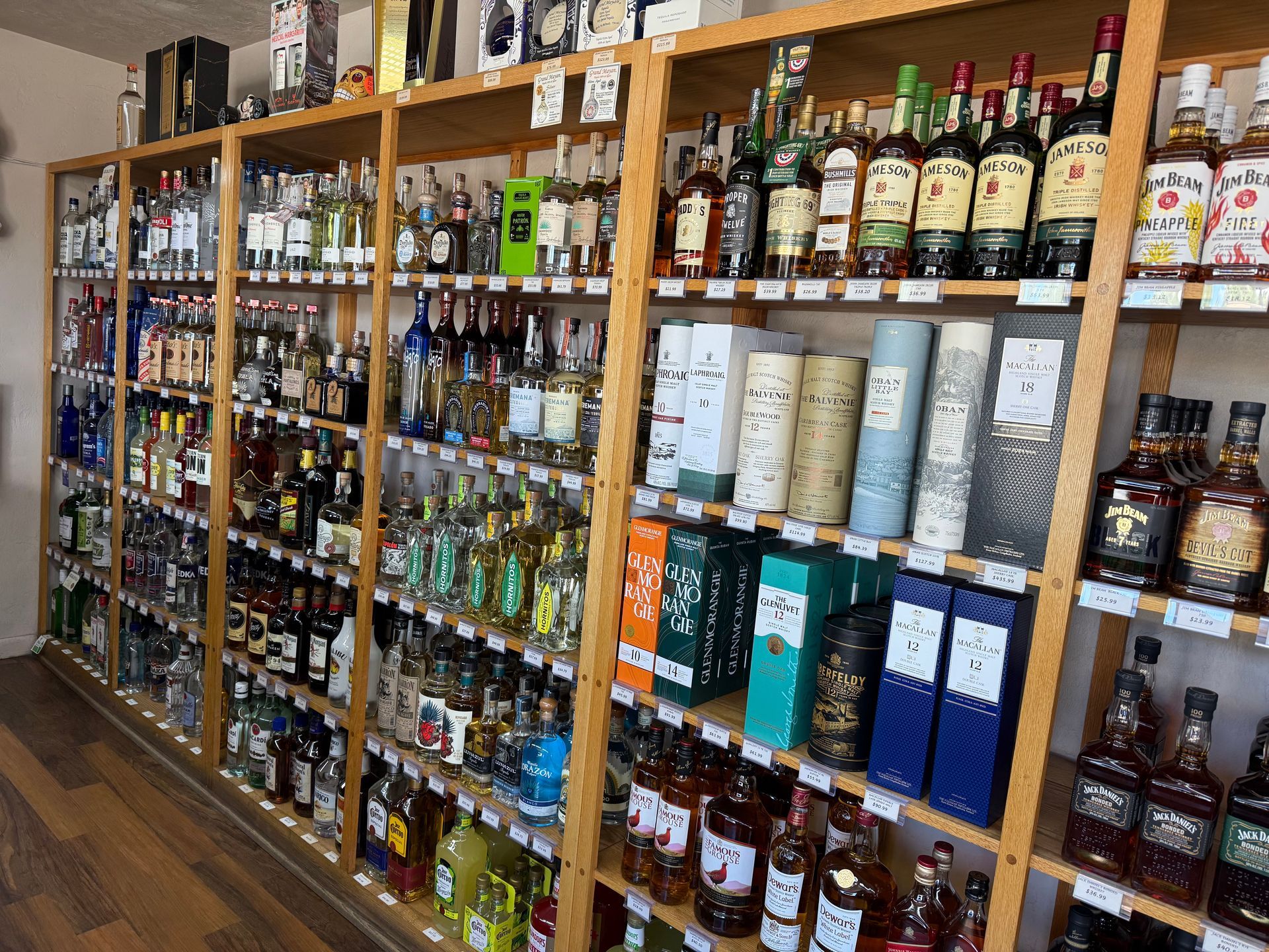 A liquor store filled with lots of bottles of liquor on shelves.