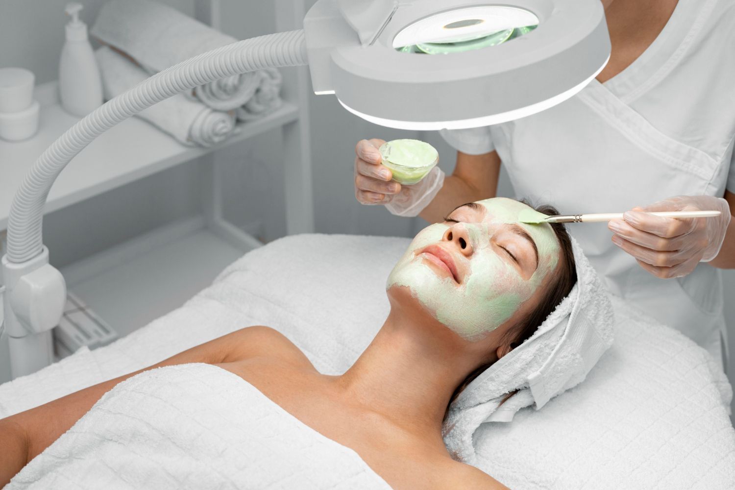 A woman is getting a facial treatment at a spa.