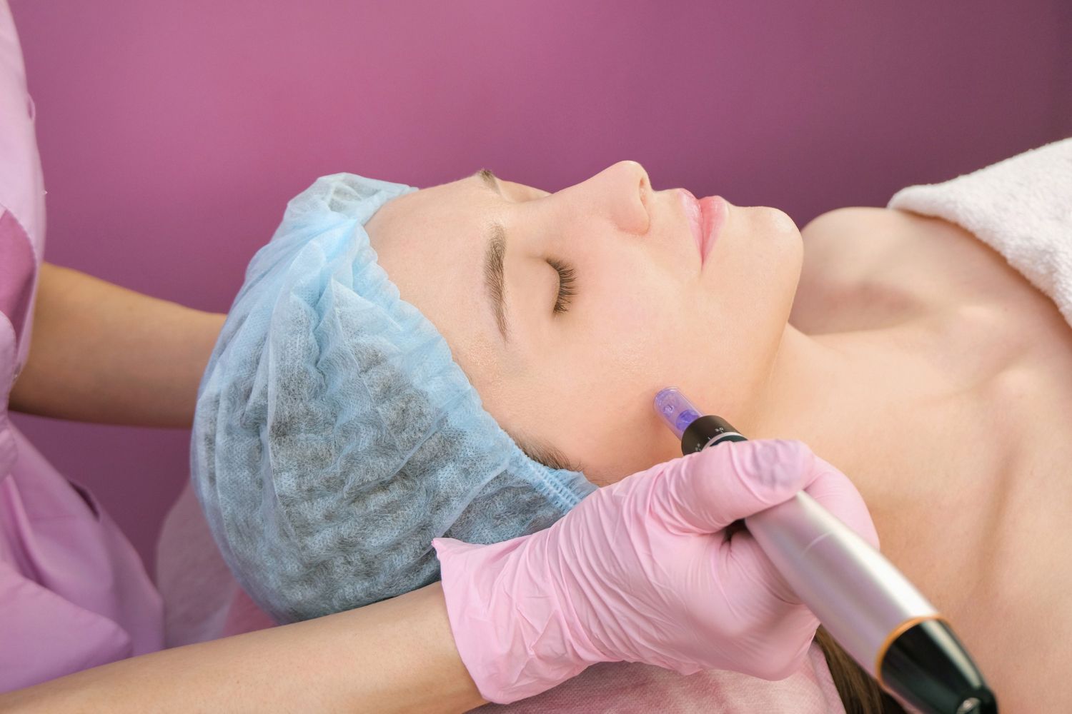 A woman is getting a facial treatment at a beauty salon.