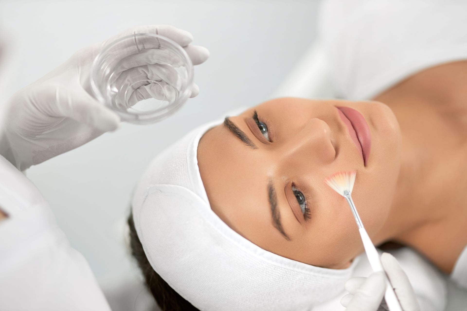 A woman is getting a facial treatment at a beauty salon.