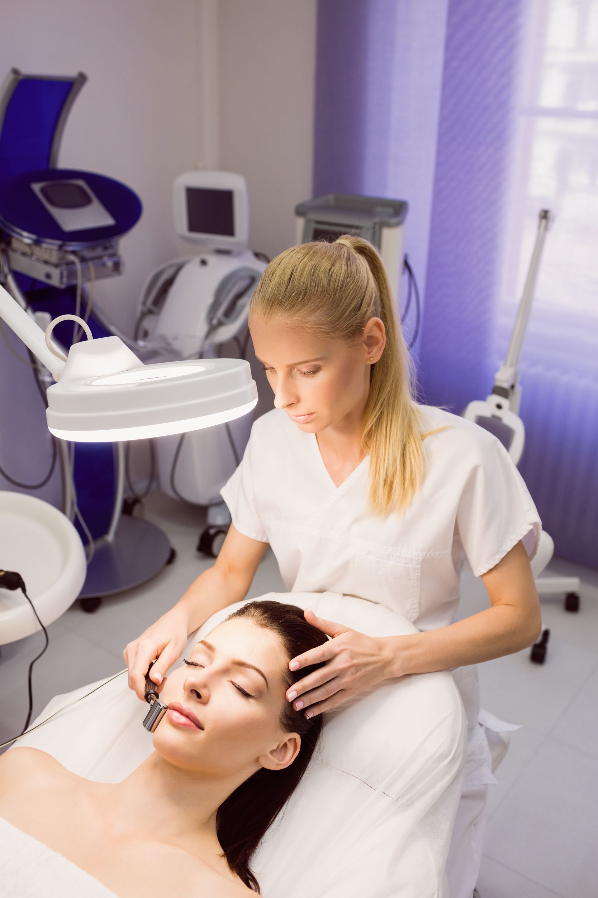 A woman is getting a facial treatment at a beauty salon