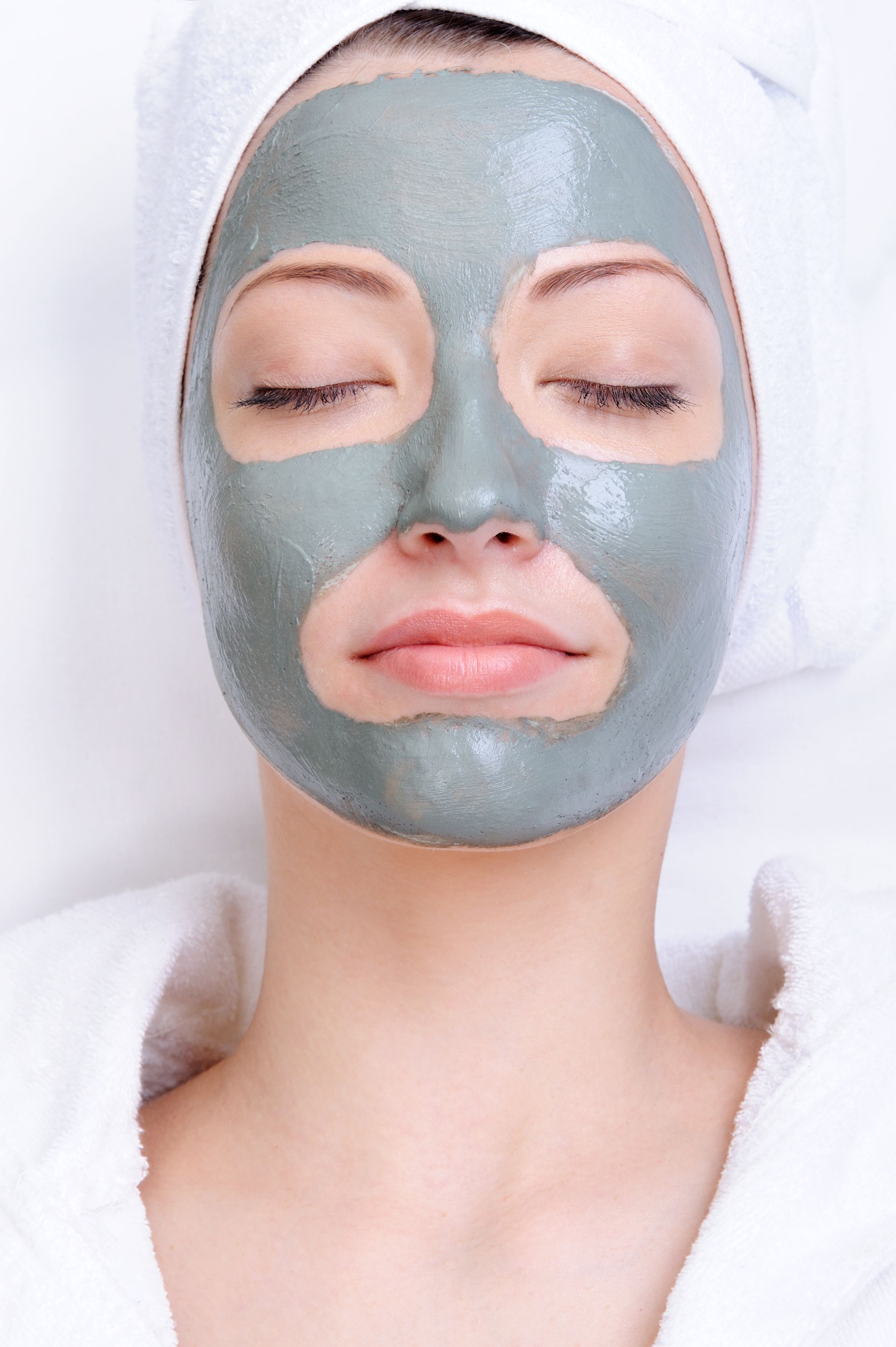 A woman is wearing a clay mask on her face.