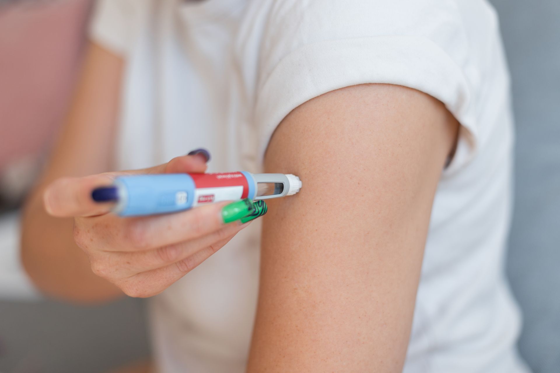 A woman is getting an injection in her arm.