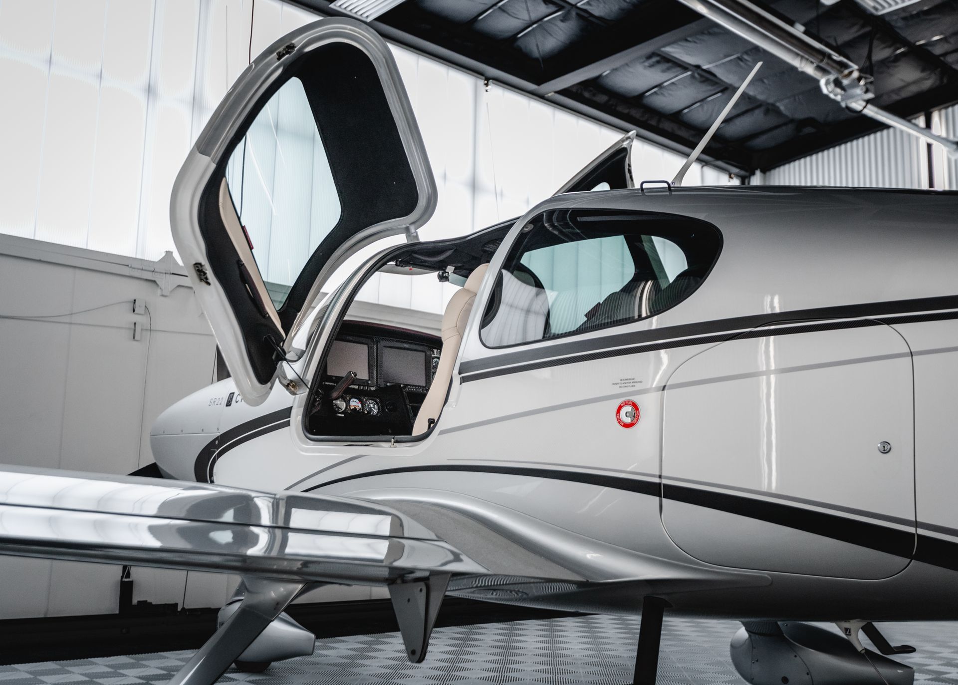 An airplane with the door open and a red circle on the side