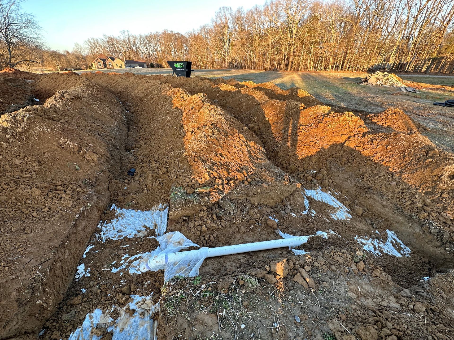 Yellow Excavator Next to A Train Track — Nashville, TN — NxtGen Excavating