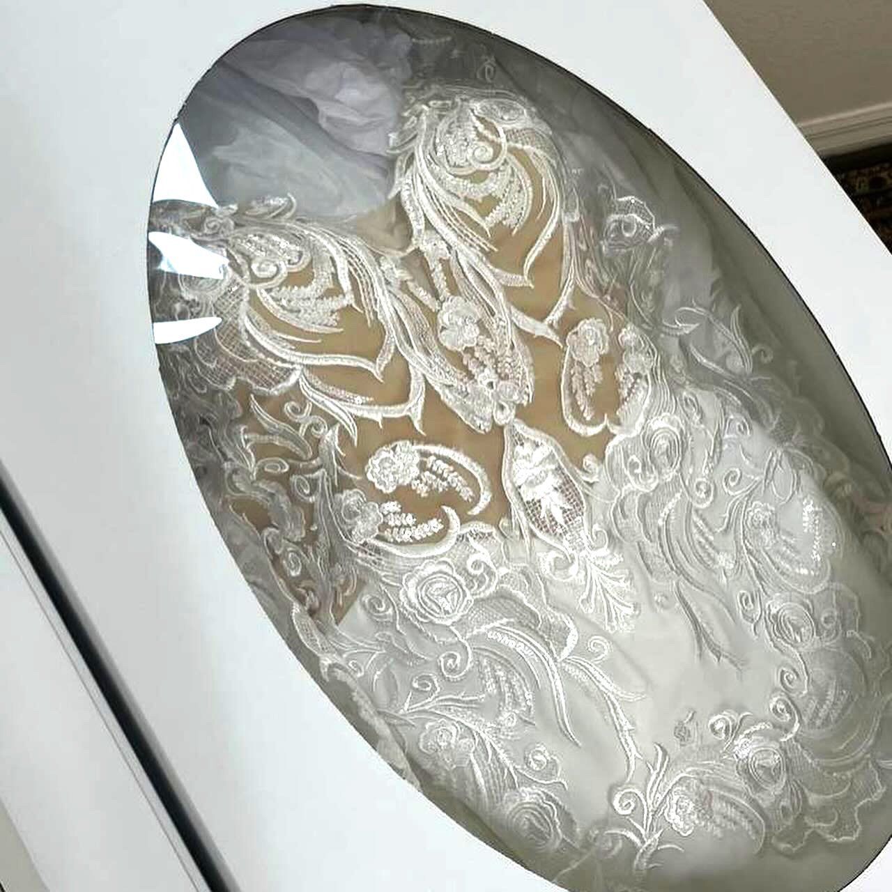 A white wedding dress is in a white box