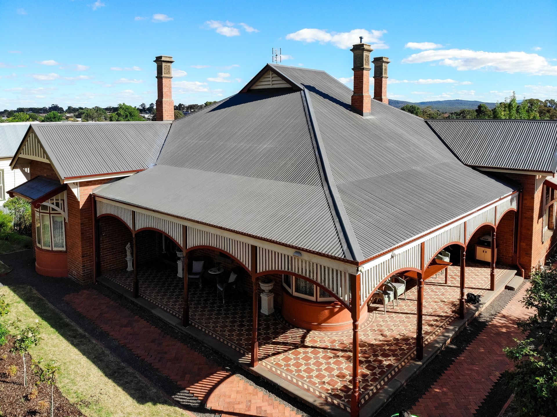 After, heritage roof replacement with new corrugated metal and custom chimney and verandah flashings, Creswick VIC.