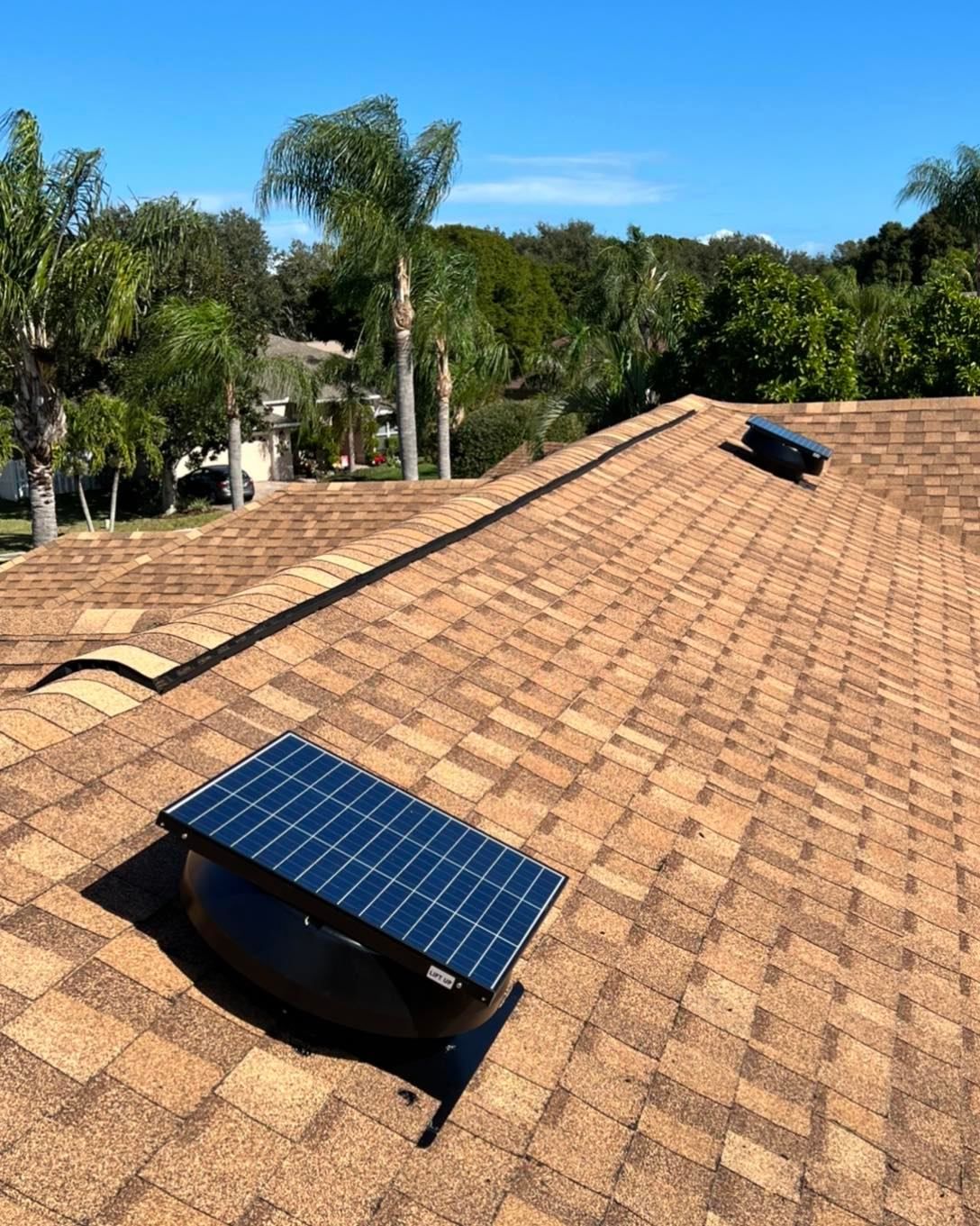 Two solar panels on the roof of a house.