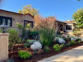 Pool area with illuminated landscaping.