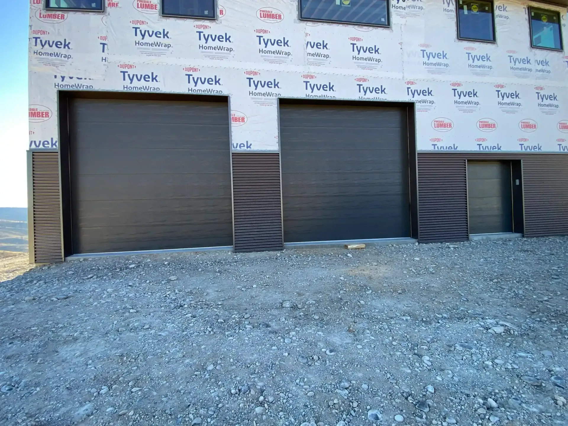 A building with a lot of windows and a garage door