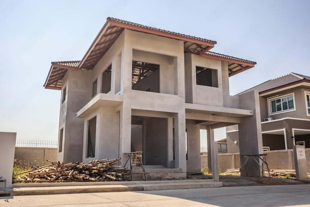 In-progress construction of a contemporary-style residential house at a new site.