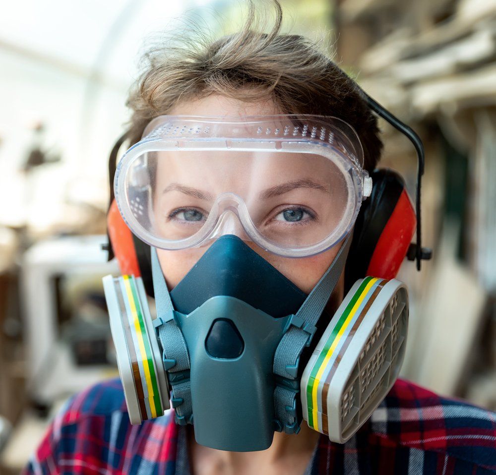 Worker Wearing Eye Protection and Gas Mask