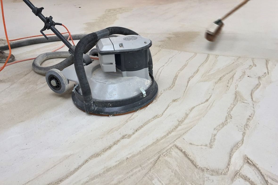 Showing how to remove liquid flow screed laitance.