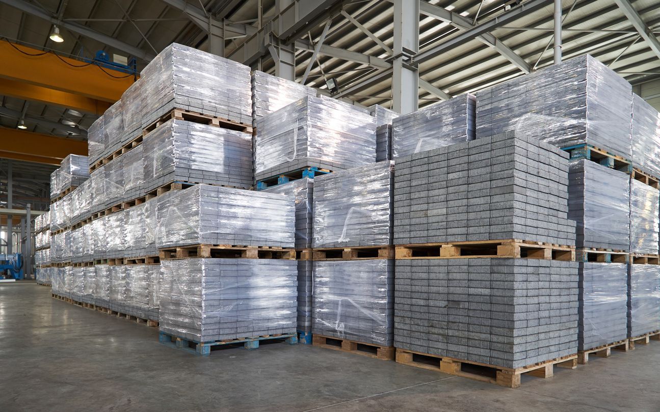 Stacks of packaged goods on pallets in a warehouse.