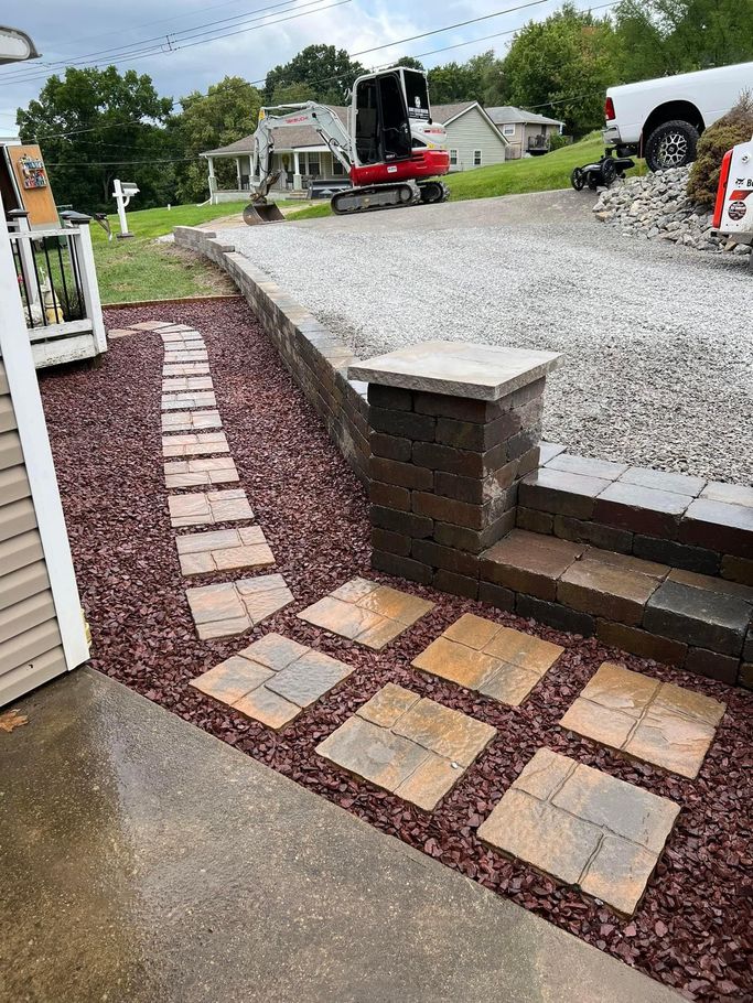 A Stone Patio with A Wooden Fence in The Background - Freedom, PA - Browns Outdoor Innovations