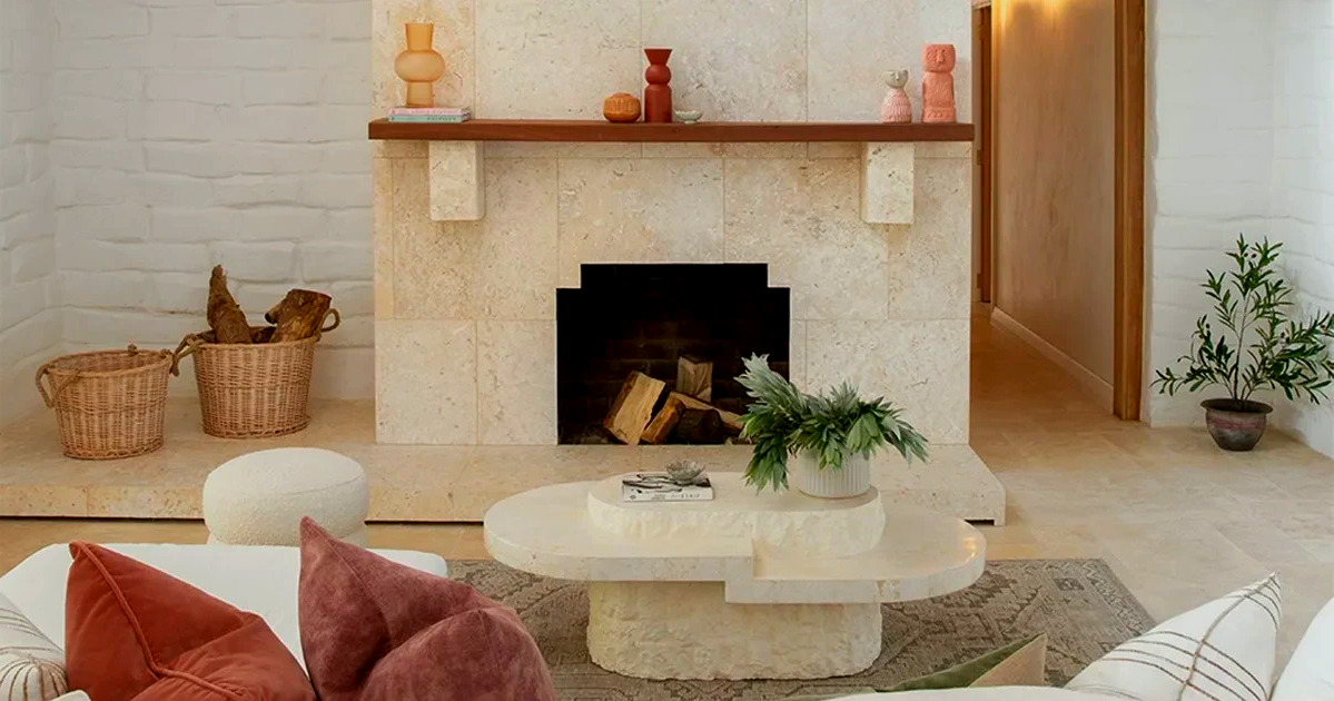 A living room with a fireplace and a coffee table.