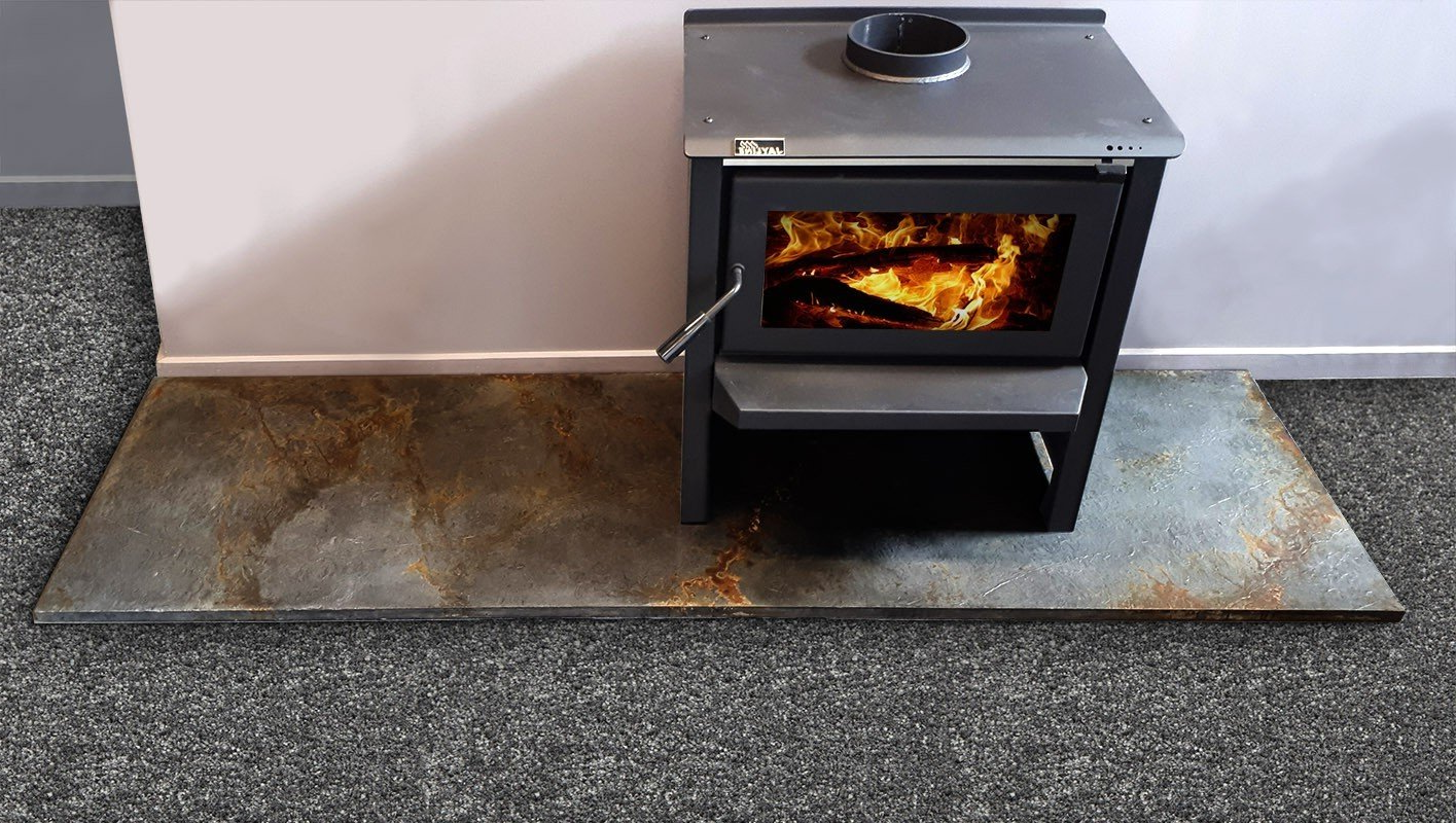 A wood stove is sitting on a carpeted floor.