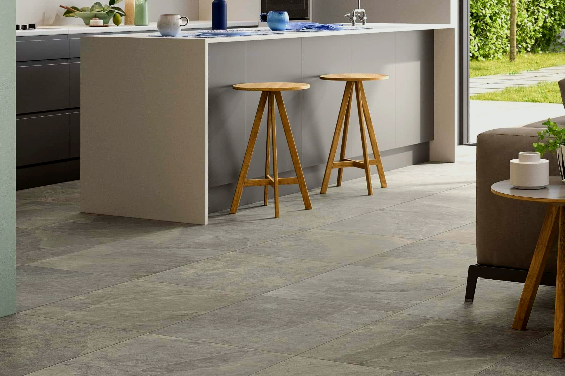 Kitchen with island, stools, and patterned gray floor.