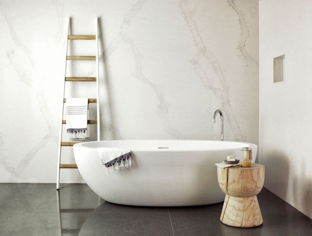 A bathroom with a bathtub and a ladder.
