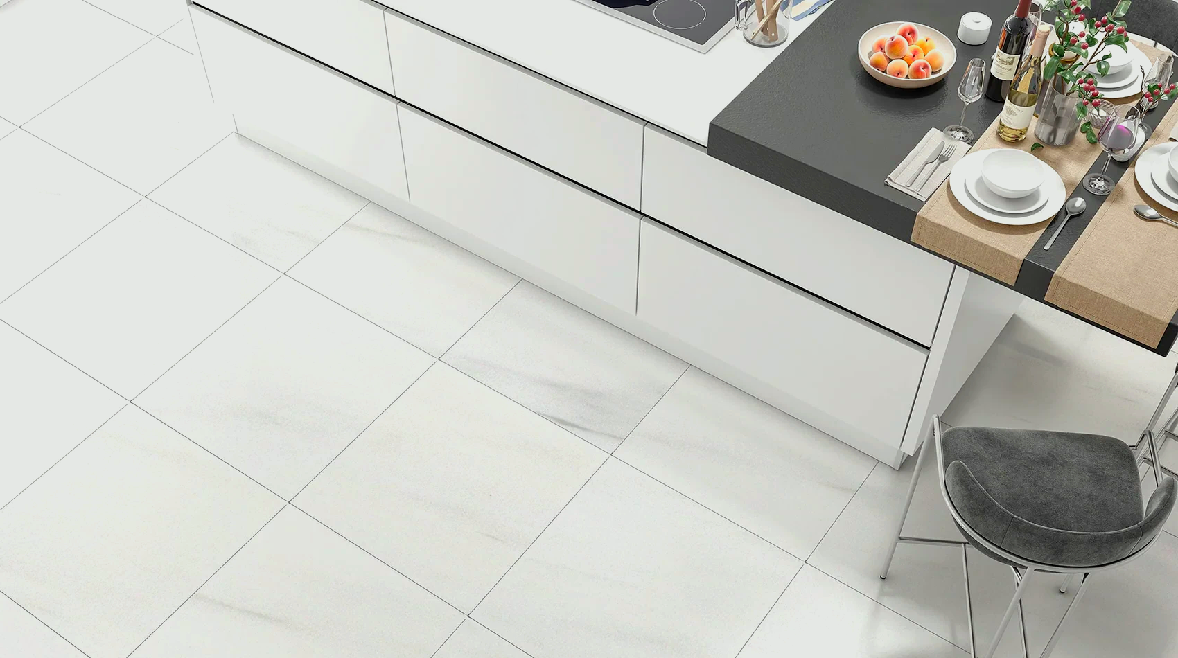 White kitchen with island and table setting. Shiny white tiled floor.