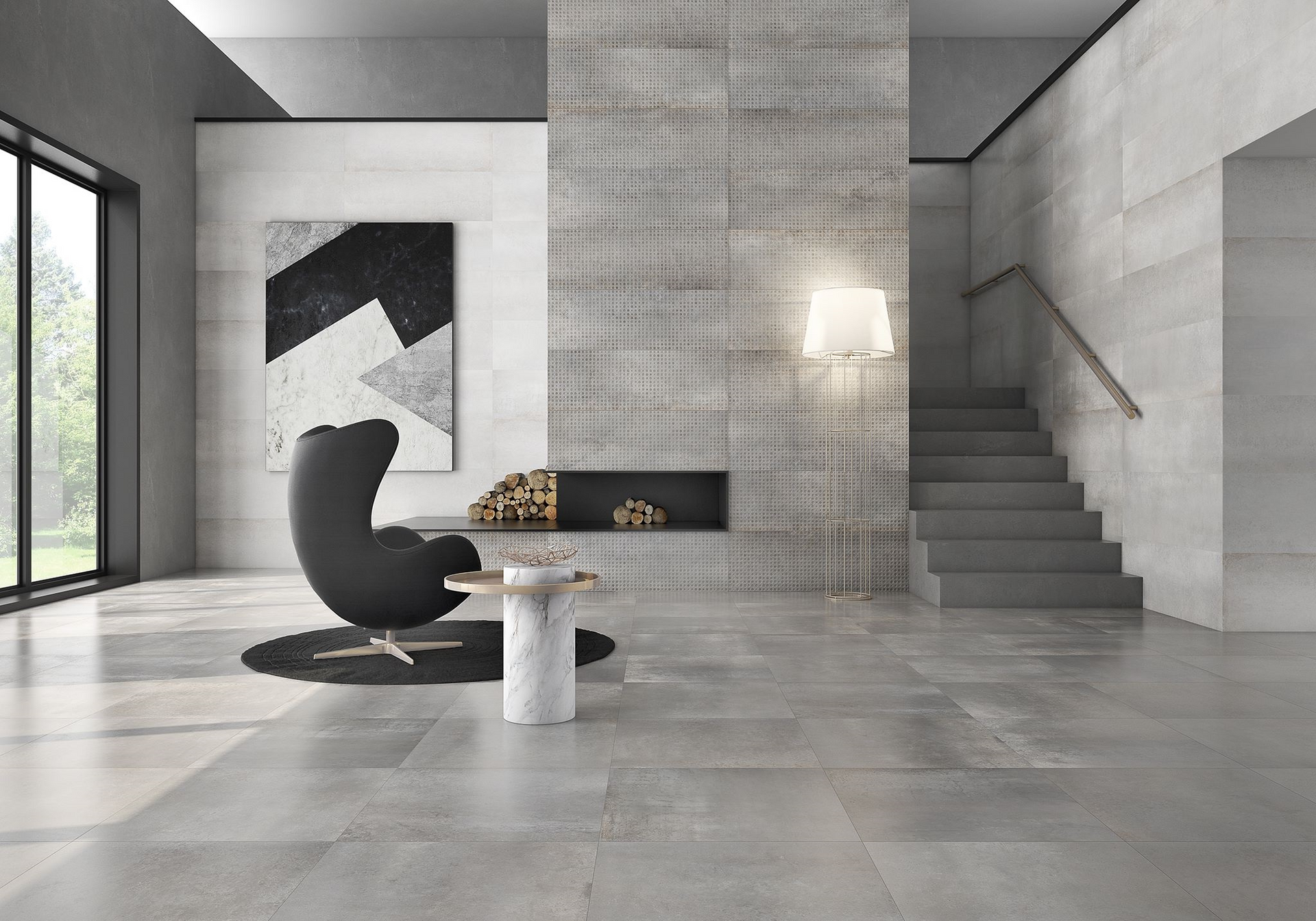 Modern living room with gray stone floors and walls, a fireplace, and a black chair.